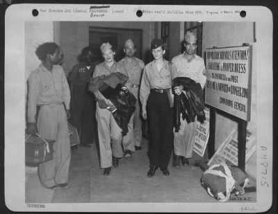 Groups > Upon Arrival At Karachi, India Via An Atc Plane From The West, Native Bearers Are On Hand To Carry Your Baggage.  Four New Arrivals Take Advantage Of The Service.  They Are, L. To R.; 2Nd Lt. Loraine Tressler, 25, Scranton, Pa., A Flight Nurse; T/3 Lonnie