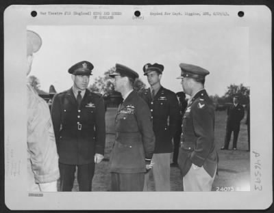 King and Queen of England > King George of England talks with high American Army officers during a visit to an Eighth Air force base to inspect the crew of the "Memphis Belle," famed Boeing B-17 Flying ofrtress.