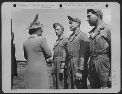 King and Queen of England > Her Majesty, The Queen Of England In Her Usual Charming Manner, Stops To Chat With Three Members Of A Ground Crew When She And The King Made A Tour Of Inspection Of The American Bomber Station In England.  Basingbourne, England. May 1943
