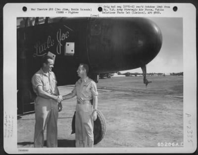 Fighter > Two Pilots Of The 318Th Fighter Group Shaking Hands Beside The Northrop P-61 Black Widow 'Little Joe' At Airfield On Iwo Jima, Bonin Islands, June 1945.