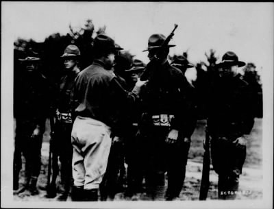1925 > Col. Denny inspects Cpl. John Coolidge and squad at C.M.T.C. Camp Devens, Mass.