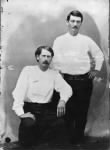 Earp, seated, and Masterson standing.jpg
