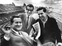 Joe Kuharich smiling over new contract given to him by new Eagles owner Jerry Wolman. VP Ed Snider in the background.jpg